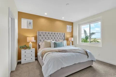 a bedroom with a large bed and a window