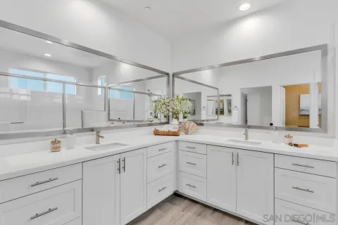 a bathroom with a sink double vanity granite and a mirror