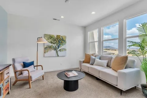 a living room with furniture and a large window