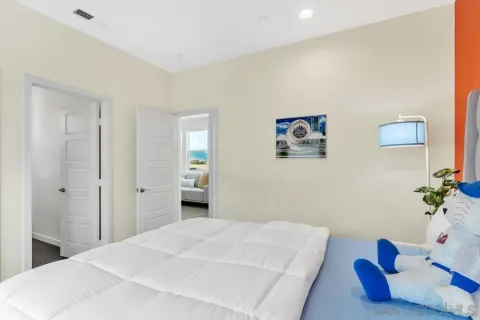 a bedroom with a bed and a potted plant