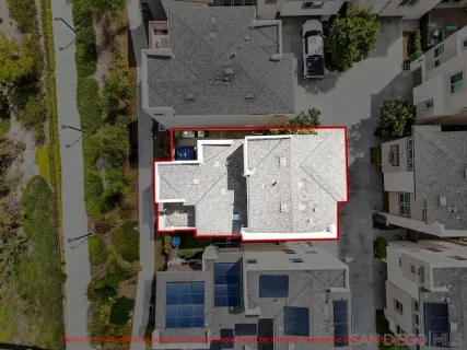 an aerial view of residential houses with outdoor space