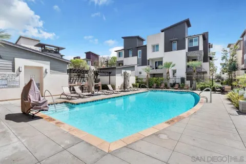 a view of a swimming pool with a patio and plants