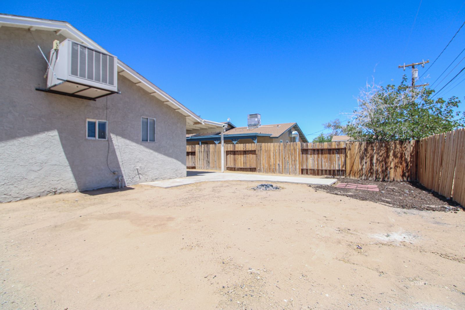 1532 South McCall Street Ridgecrest, CA 93555 - Photo 26 of 27 a front view of a house with a yard and garage