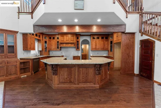 a kitchen with stainless steel appliances granite countertop a stove and a sink