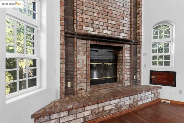 a view of a room with lots of wooden furniture and windows