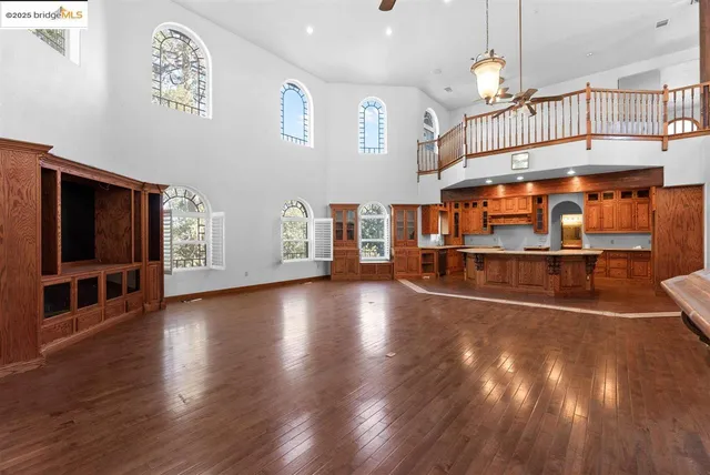 a bathroom with a toilet a sink a mirror and a window