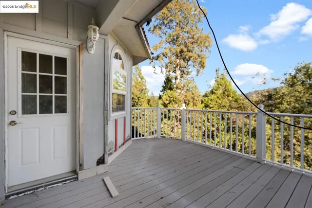 a view of a room with a chandelier and wooden floor