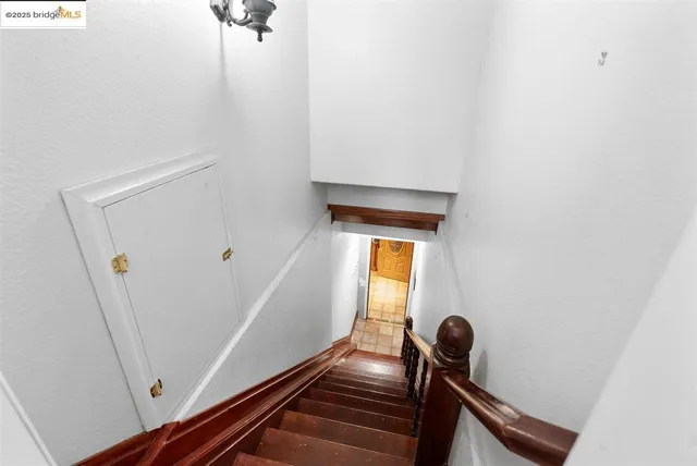 a view of a livingroom with a chandelier furniture and windows