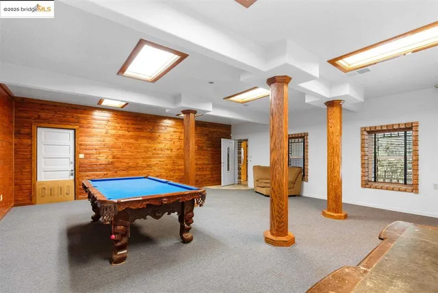 a large kitchen with stainless steel appliances granite countertop a stove a sink and a refrigerator