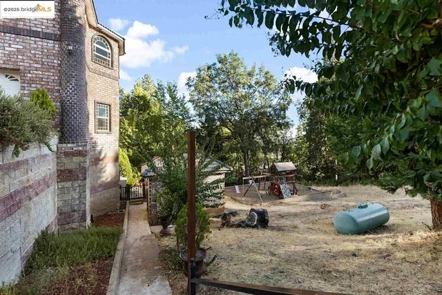 a view of a house with a mountain and a forest
