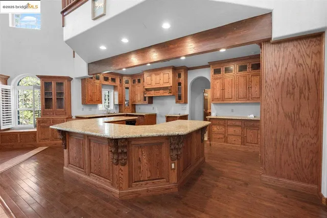 wooden floor fireplace and windows in an empty room