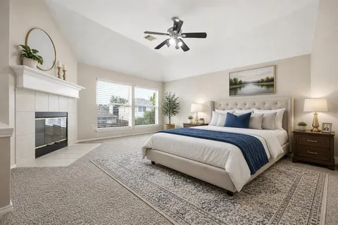 a spacious bedroom with a large bed and a fireplace