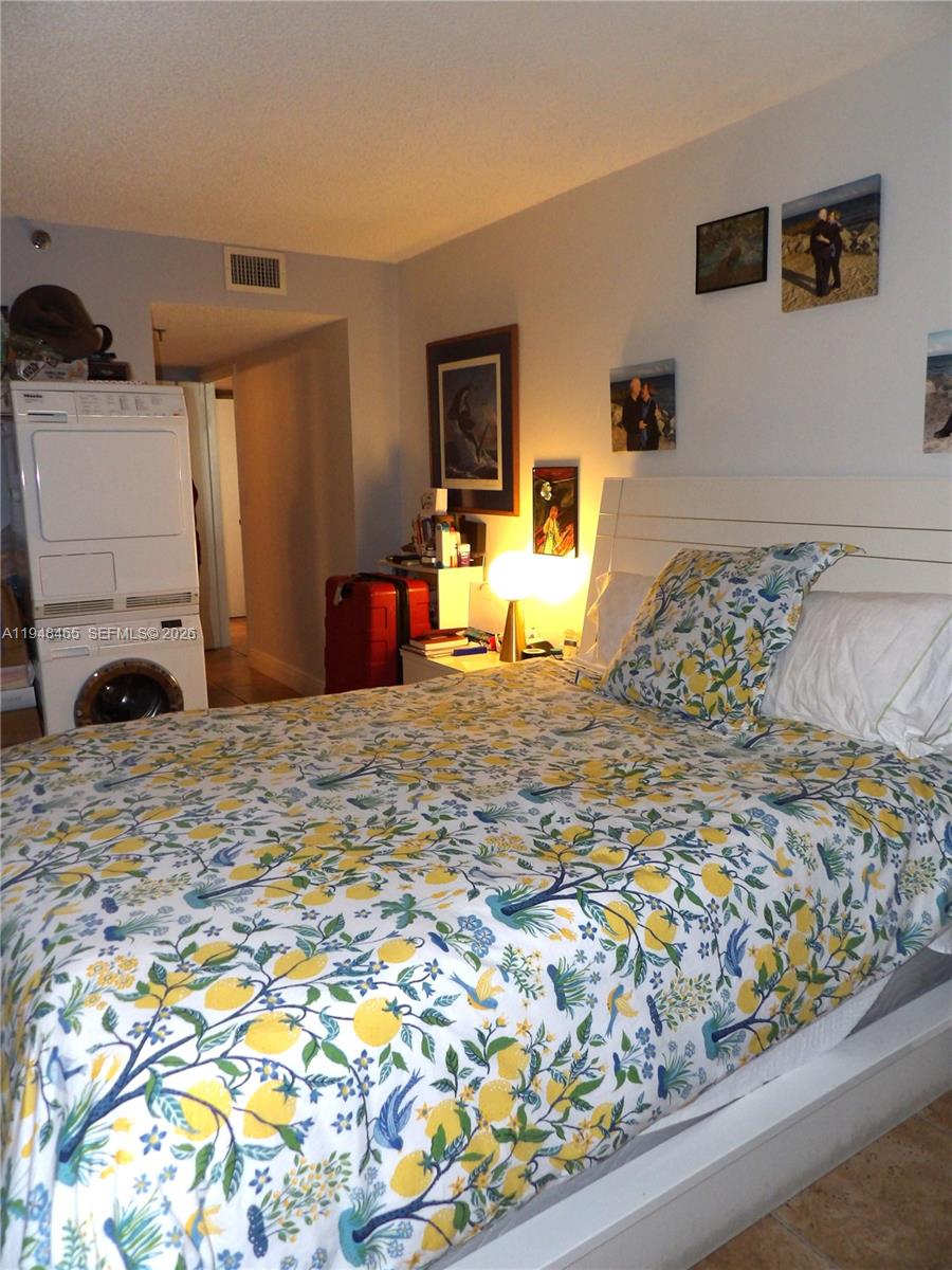 555 Northeast 15th Street, Unit 14E Miami, FL 33132 - Photo 7 of 26 a bedroom with a bed and a flat screen tv