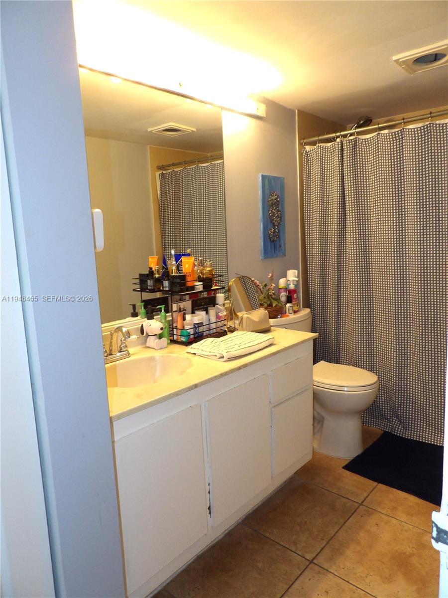 555 Northeast 15th Street, Unit 14E Miami, FL 33132 - Photo 8 of 26 a bathroom with a double vanity sink toilet and a mirror