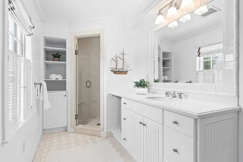 a spacious bathroom with a double vanity sink mirror and bathtub