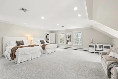 an aerial view of residential house with outdoor space and trees all around