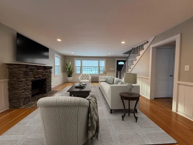 a living room with furniture a fireplace and a flat screen tv