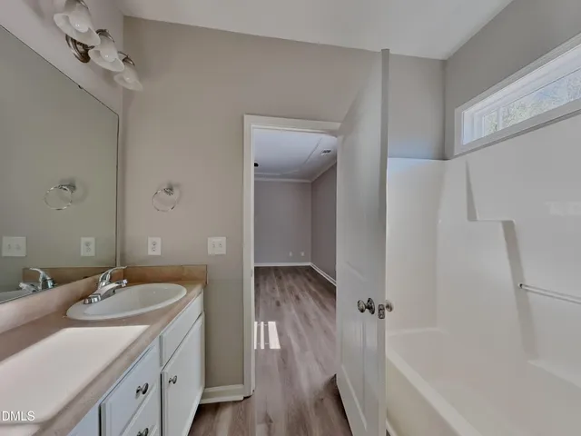 a bathroom with a bathtub and a sink