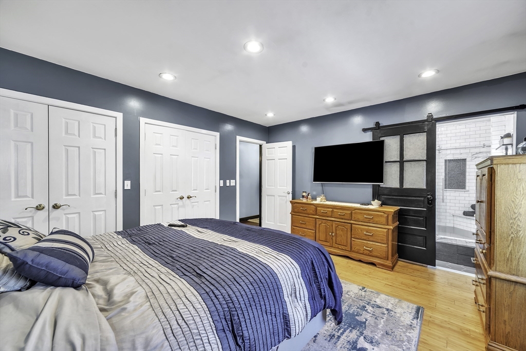 32 Stebbins Road Monson, MA 01057 - Photo 14 of 33 a bedroom with a bed and a flat screen tv