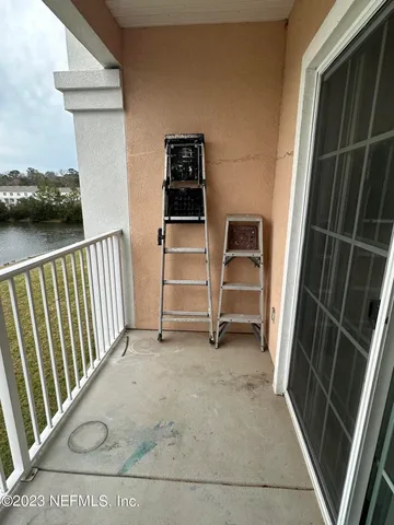 a view of empty room with stairs and a window