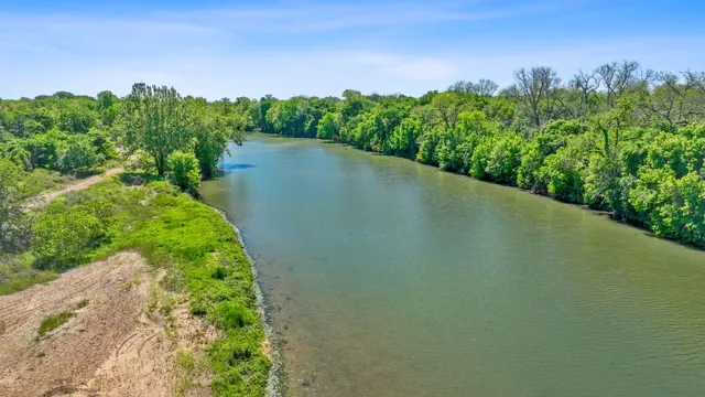 a view of a lush green outdoor space with a lake view