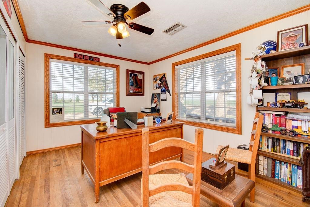 3298 Hawk Road Levelland, TX 79336 - Photo 22 of 32 a view of a workspace with furniture and a window