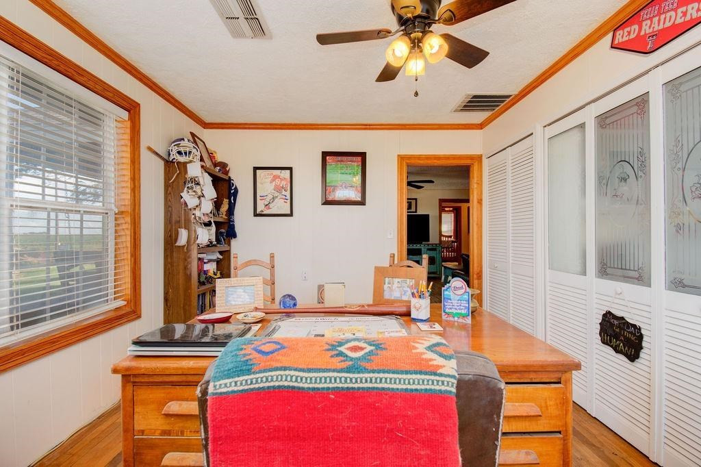 3298 Hawk Road Levelland, TX 79336 - Photo 23 of 32 a bedroom with a bed and a flat screen tv