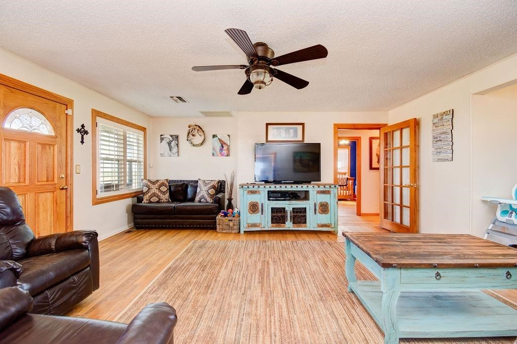 3298 Hawk Road Levelland, TX 79336 - Photo 6 of 32 a living room with furniture and a flat screen tv