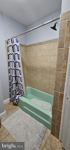 a bathroom with a shower and a bathtub