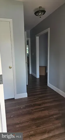 a view of a hallway view with wooden floor and staircase