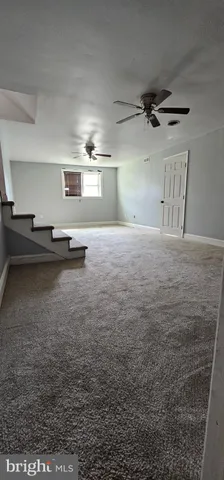 a view of a livingroom with furniture and a window