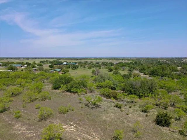 a view of a big yard with lots of green space