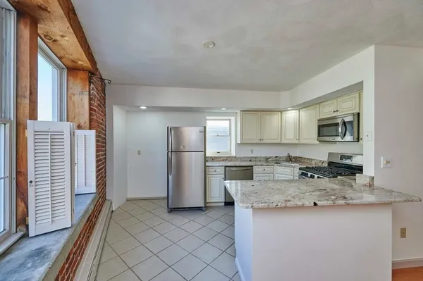 a kitchen with refrigerator and cabinets
