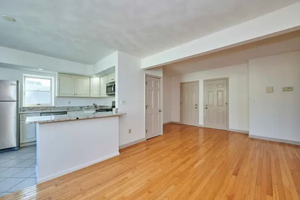a view of a kitchen with granite countertop cabinets and wooden floor