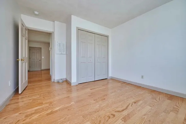 a view of an empty room with closet area