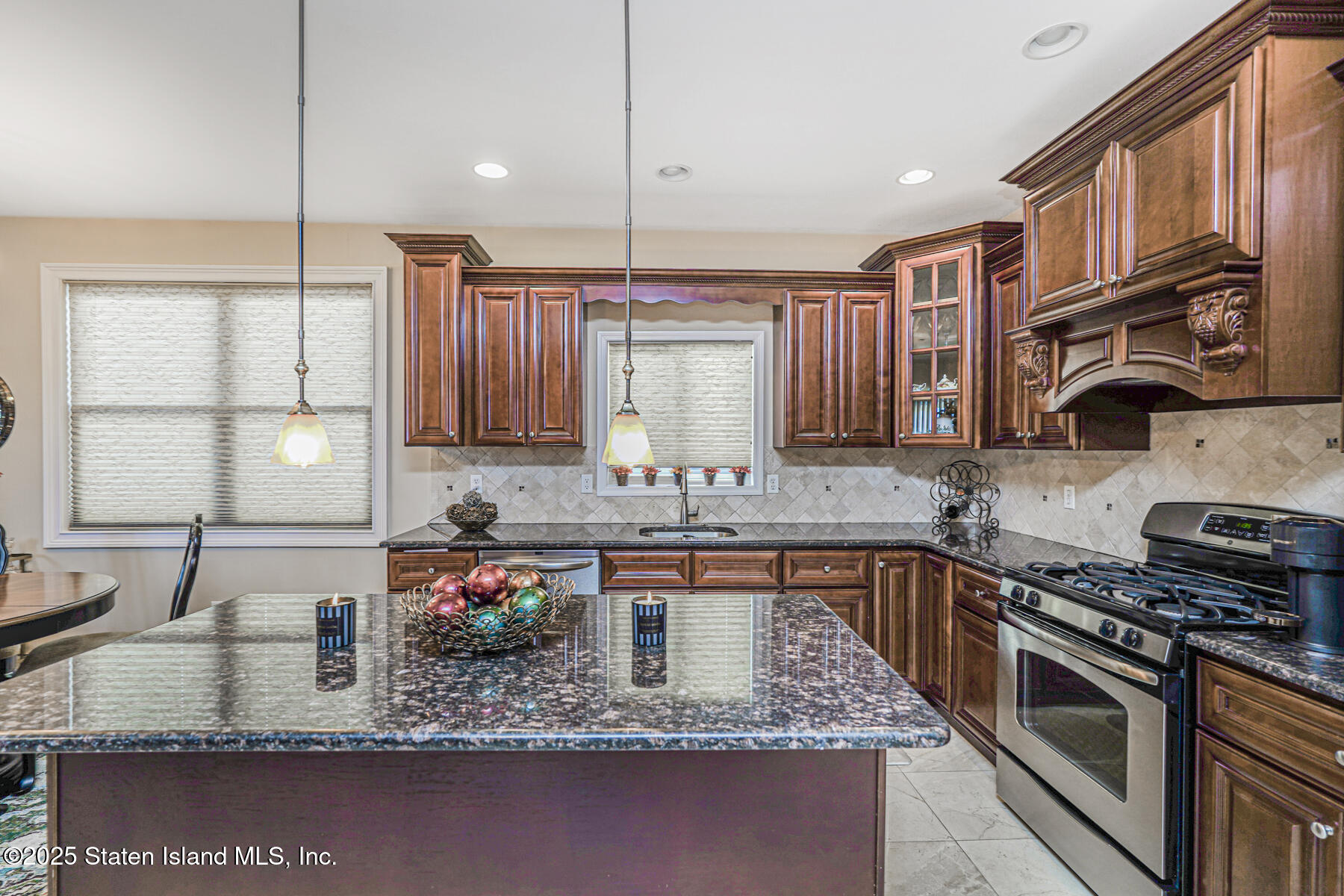 1352 Forest Hill Road Staten Island, NY 10314 - Photo 11 of 19 a kitchen with stainless steel appliances granite countertop a sink a stove and a wooden cabinets