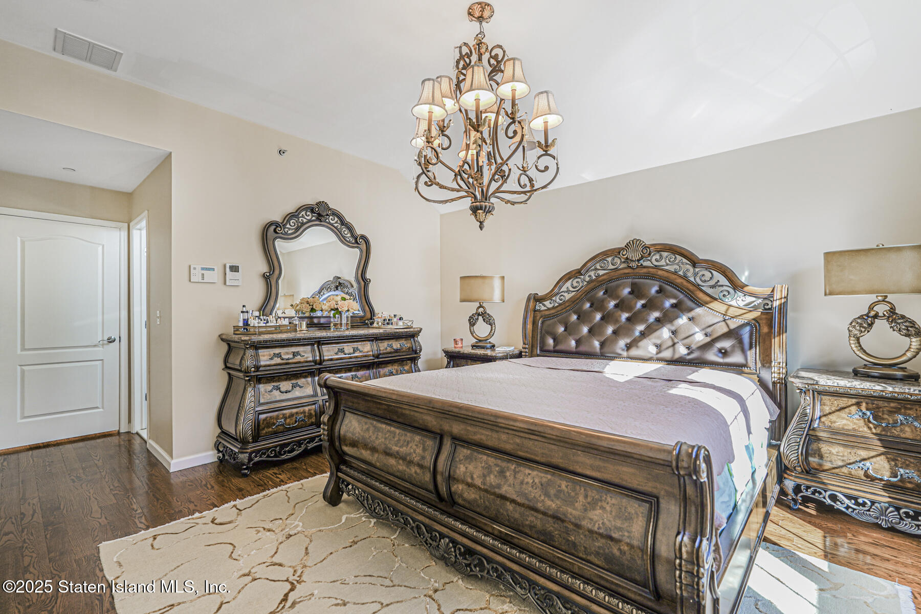 1352 Forest Hill Road Staten Island, NY 10314 - Photo 13 of 19 a bedroom with bed and wooden floor