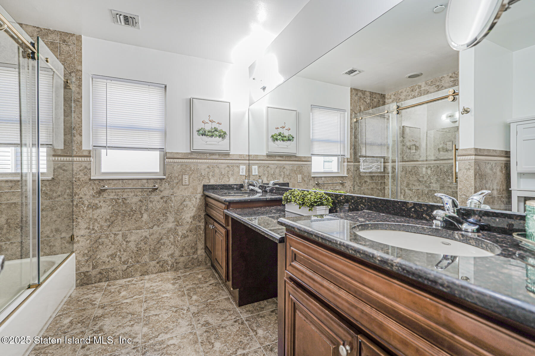 1352 Forest Hill Road Staten Island, NY 10314 - Photo 14 of 19 a bathroom with a granite countertop sink a mirror and a shower