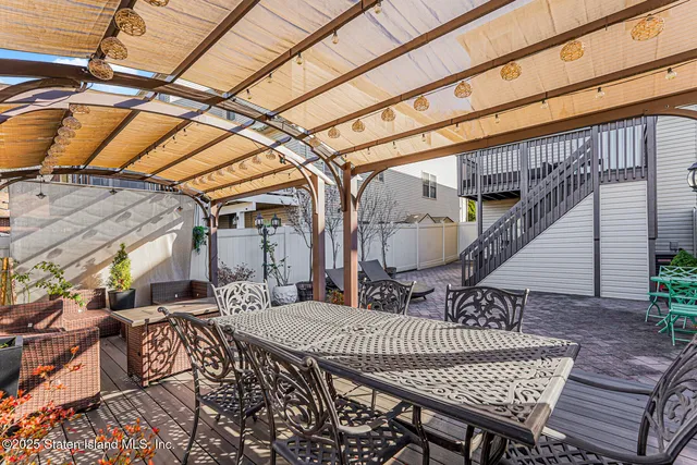 a view of backyard with roof deck and furniture