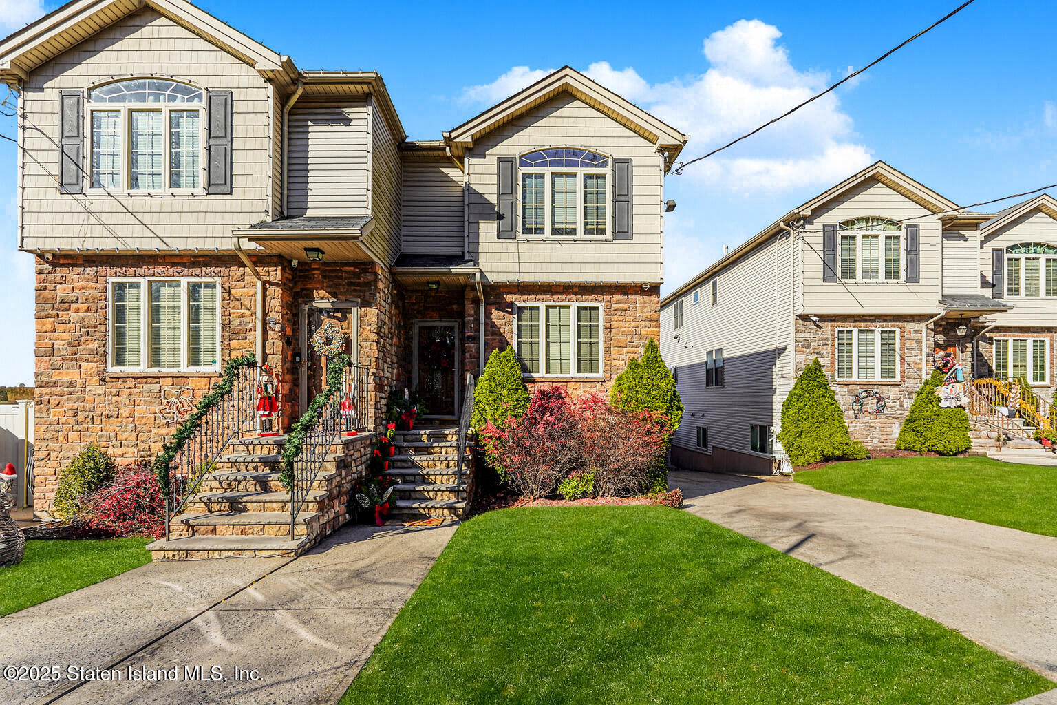 1352 Forest Hill Road Staten Island, NY 10314 - Photo 2 of 19 a front view of a house with a yard and garage
