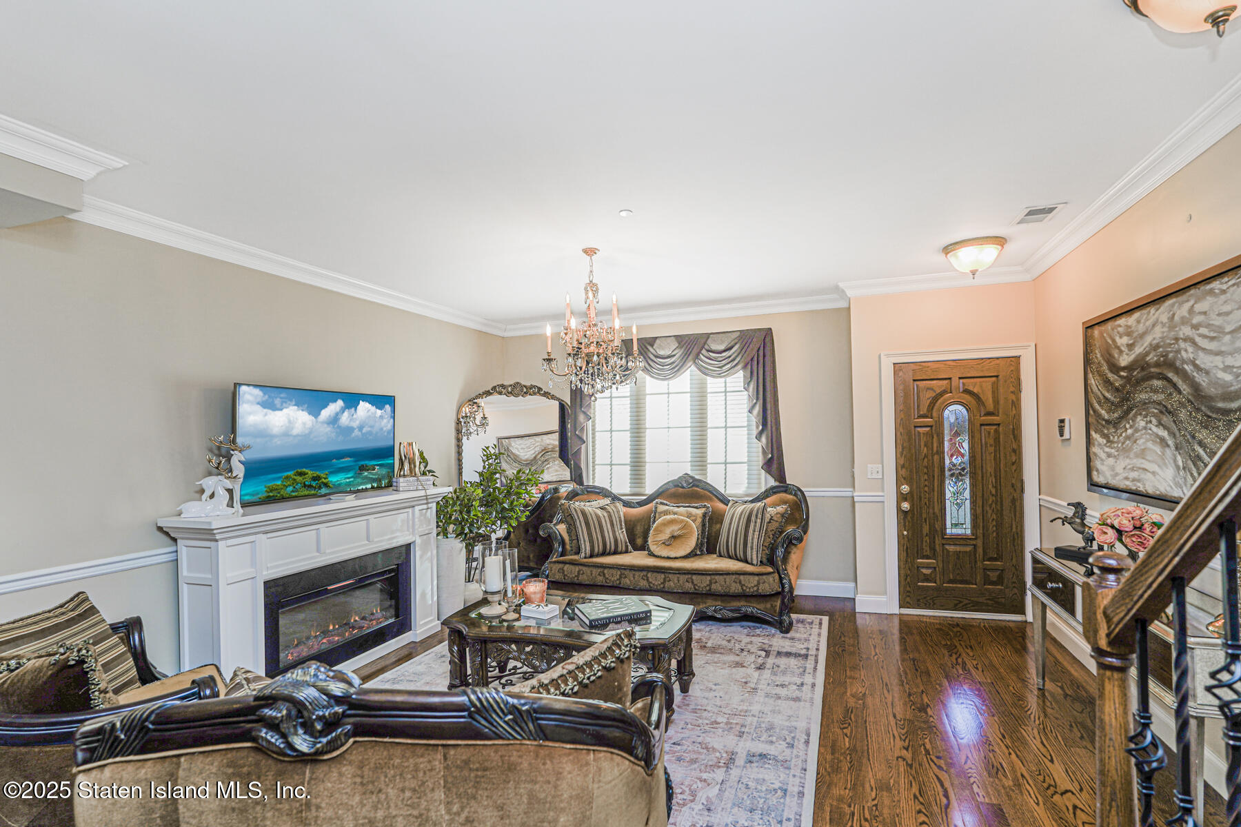 1352 Forest Hill Road Staten Island, NY 10314 - Photo 4 of 19 a living room with furniture a fireplace and a flat screen tv