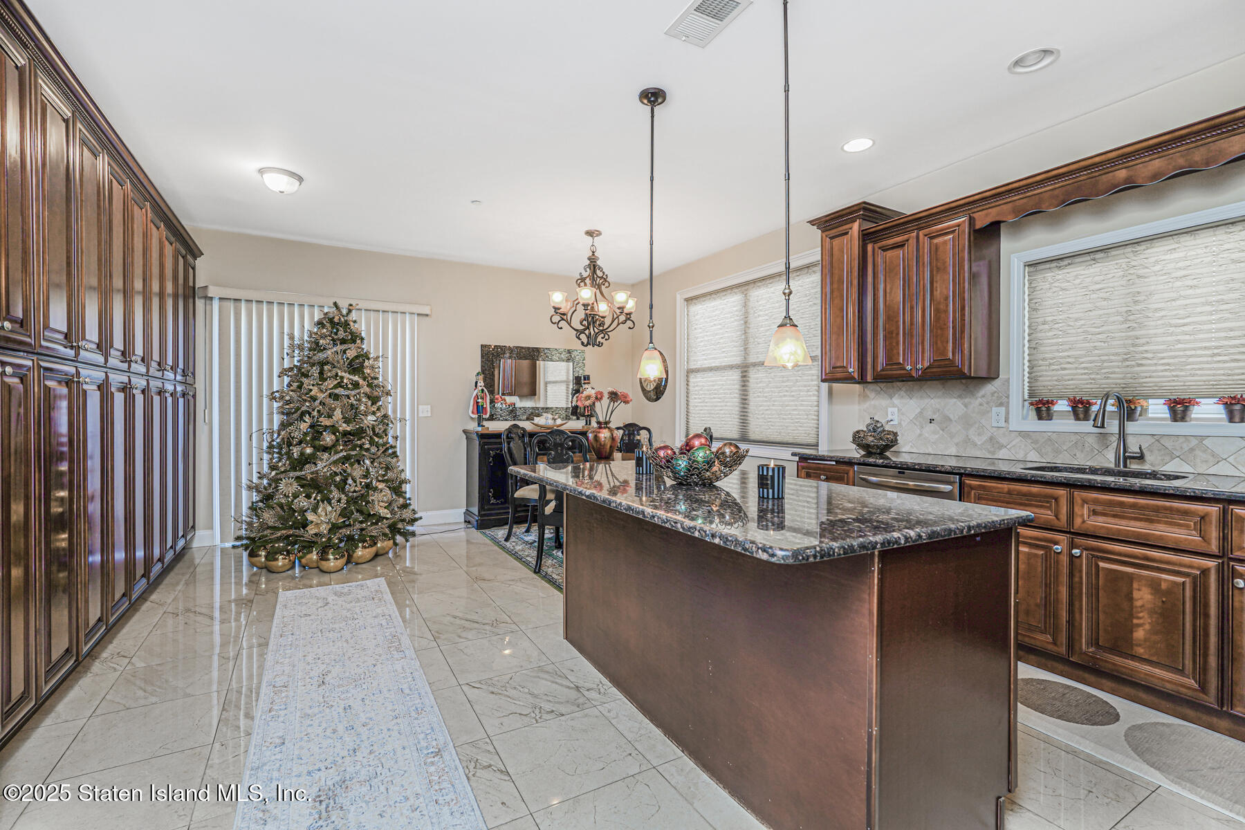 1352 Forest Hill Road Staten Island, NY 10314 - Photo 7 of 19 a kitchen with kitchen island granite countertop a sink stove and cabinets