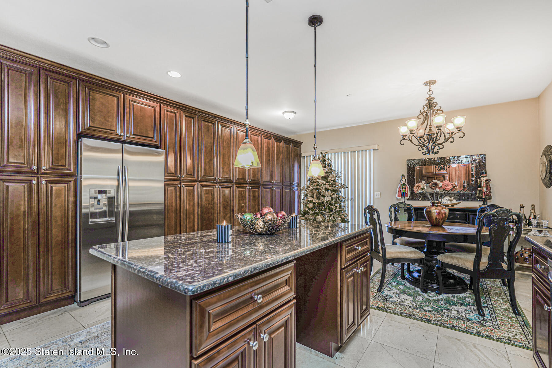 1352 Forest Hill Road Staten Island, NY 10314 - Photo 10 of 19 a kitchen with granite countertop kitchen island stainless steel appliances a table chairs sink and wooden floor