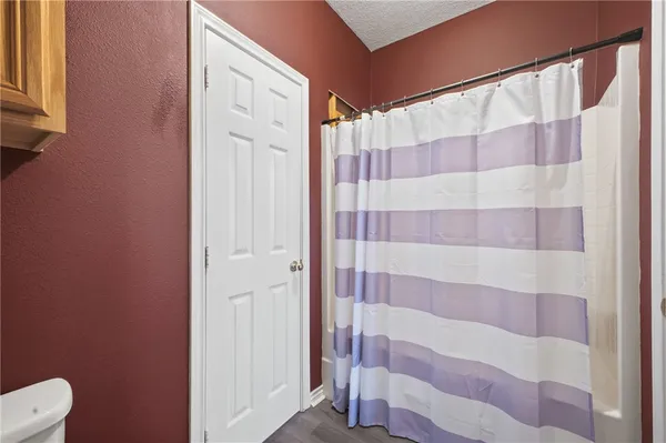 a bathroom with a shower and a toilet