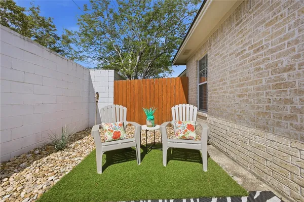 a backyard of a house with table and chairs