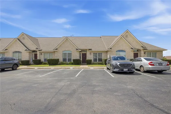 a view of a large car parked in front of a house