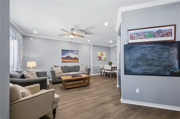 a living room with furniture and wooden floor