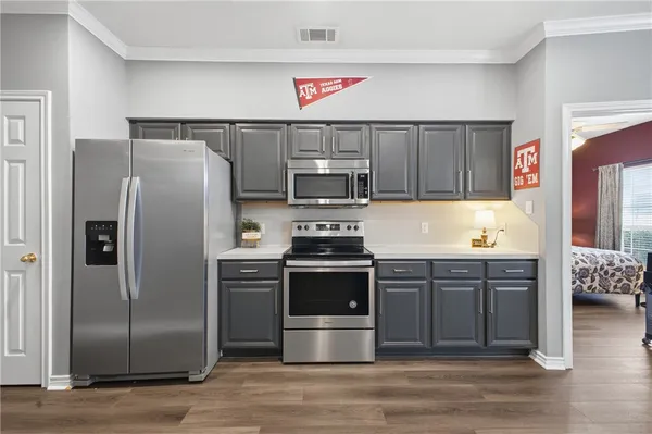 a kitchen with stainless steel appliances granite countertop a refrigerator stove and sink