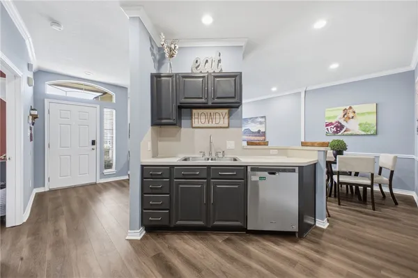 a kitchen with stainless steel appliances granite countertop a stove and cabinets
