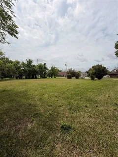 a view of a field with an ocean view